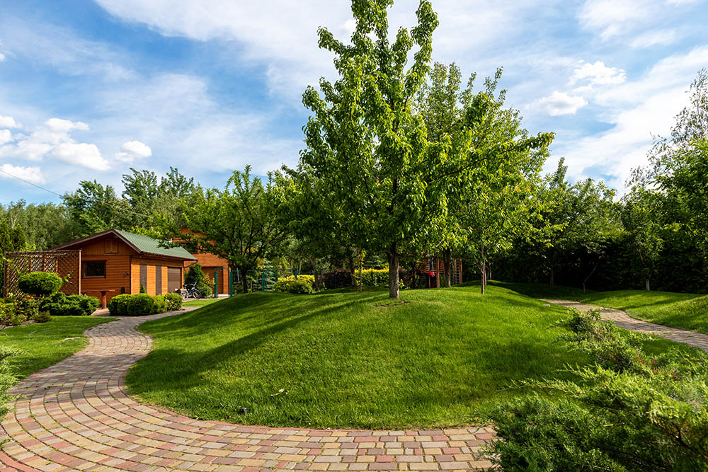 The landscaping contractors in Utah at Hot Shot built a beautiful brick path around this lawn and house.