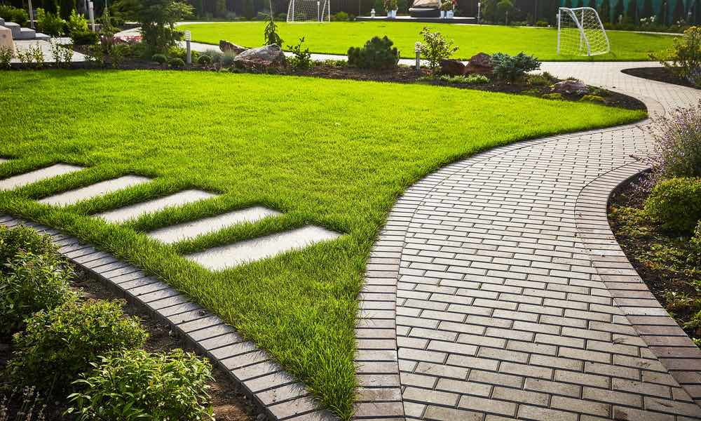 This pathway through a beautifully designed yard was installed by Hot Shot Sprinkler Repair & Landscape.