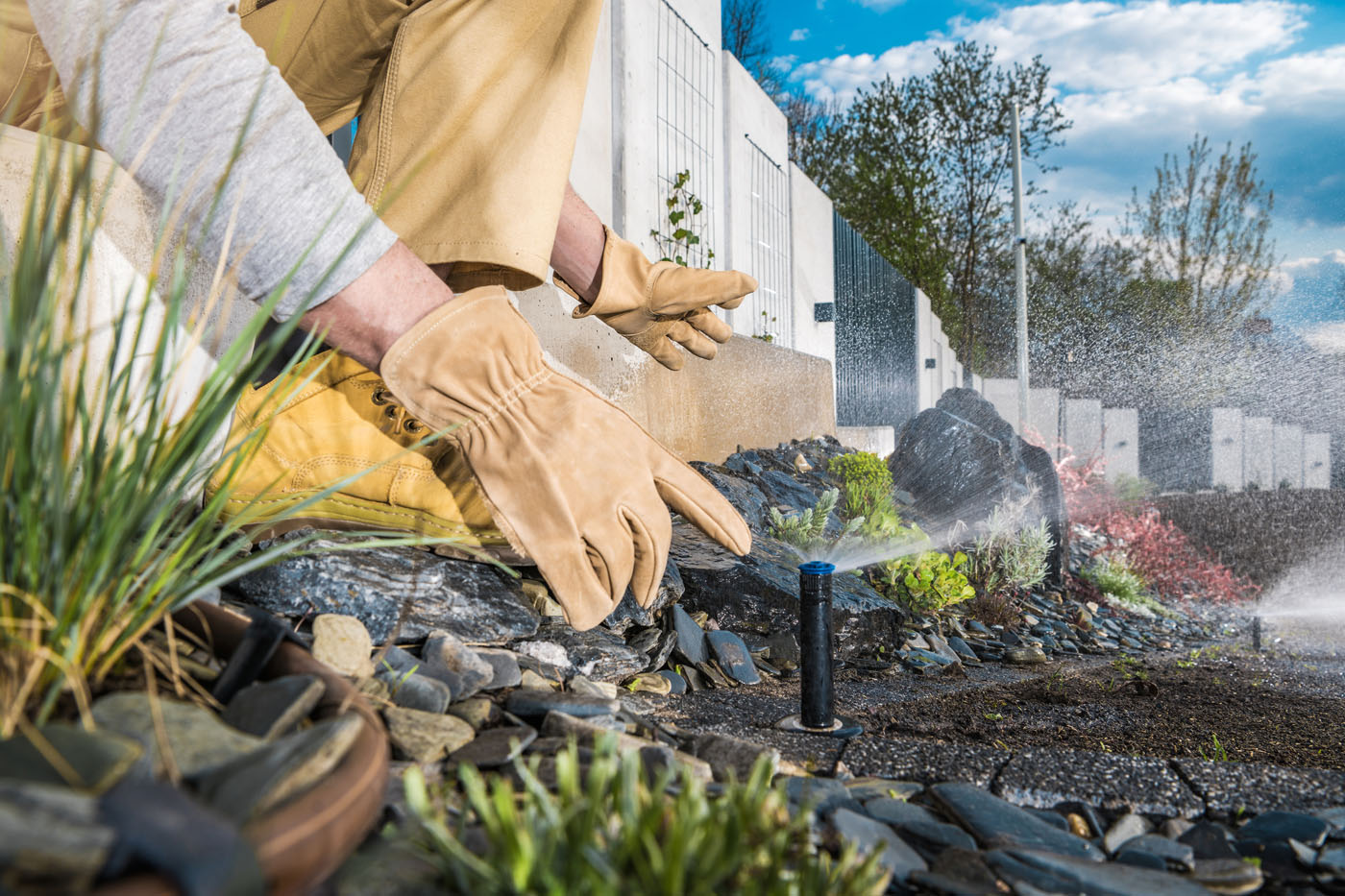 A healthy, green lawn being watered by a new sprinkler system installed by Hot Shot Sprinkler Repair & Landscape.